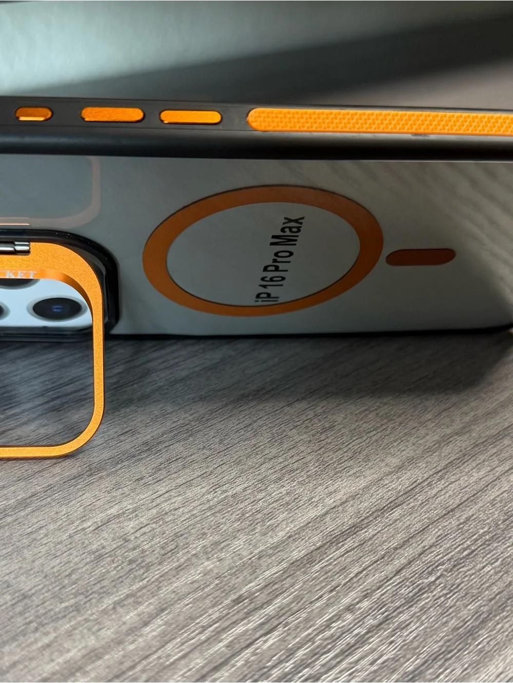Transparent iPhone 16 Pro Max case, orange and black, MagSafe compatible.